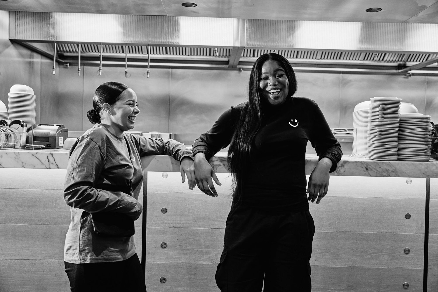Two coworkers laughing together at work