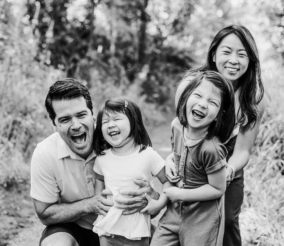 A family laughing together outdoors